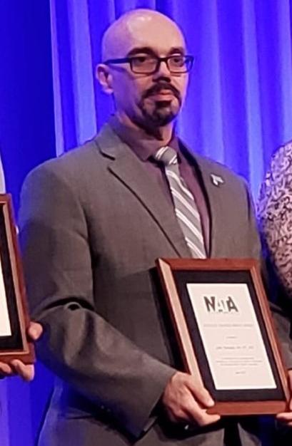 John Furtado accepting the 2019 Athletic Trainer Service Award.